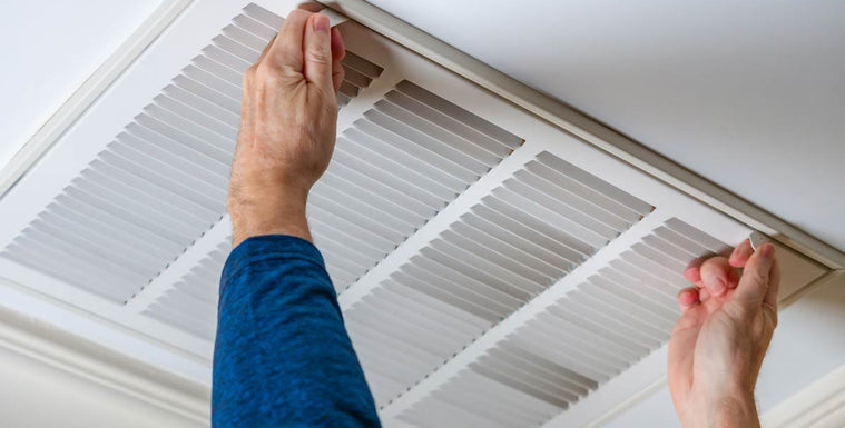 Man pulling open overhead vent door