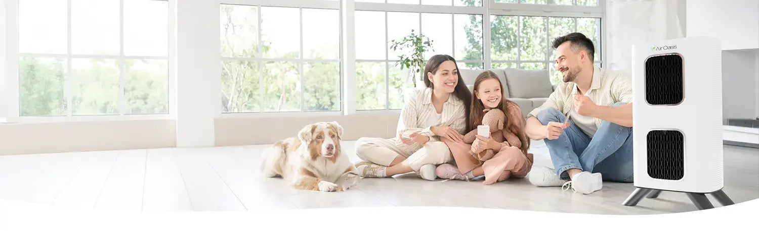 a family sitting on the floor with their dog in a living room with an iAdaptAir air purifier